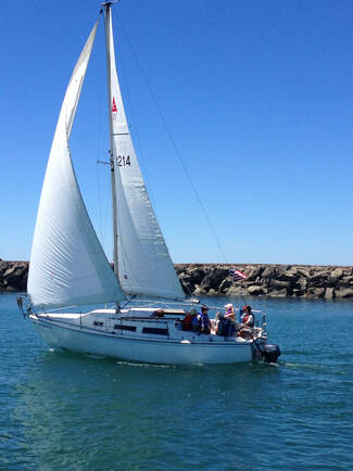 Sailboat carrying passengers near the Yaquina Bay entrance
